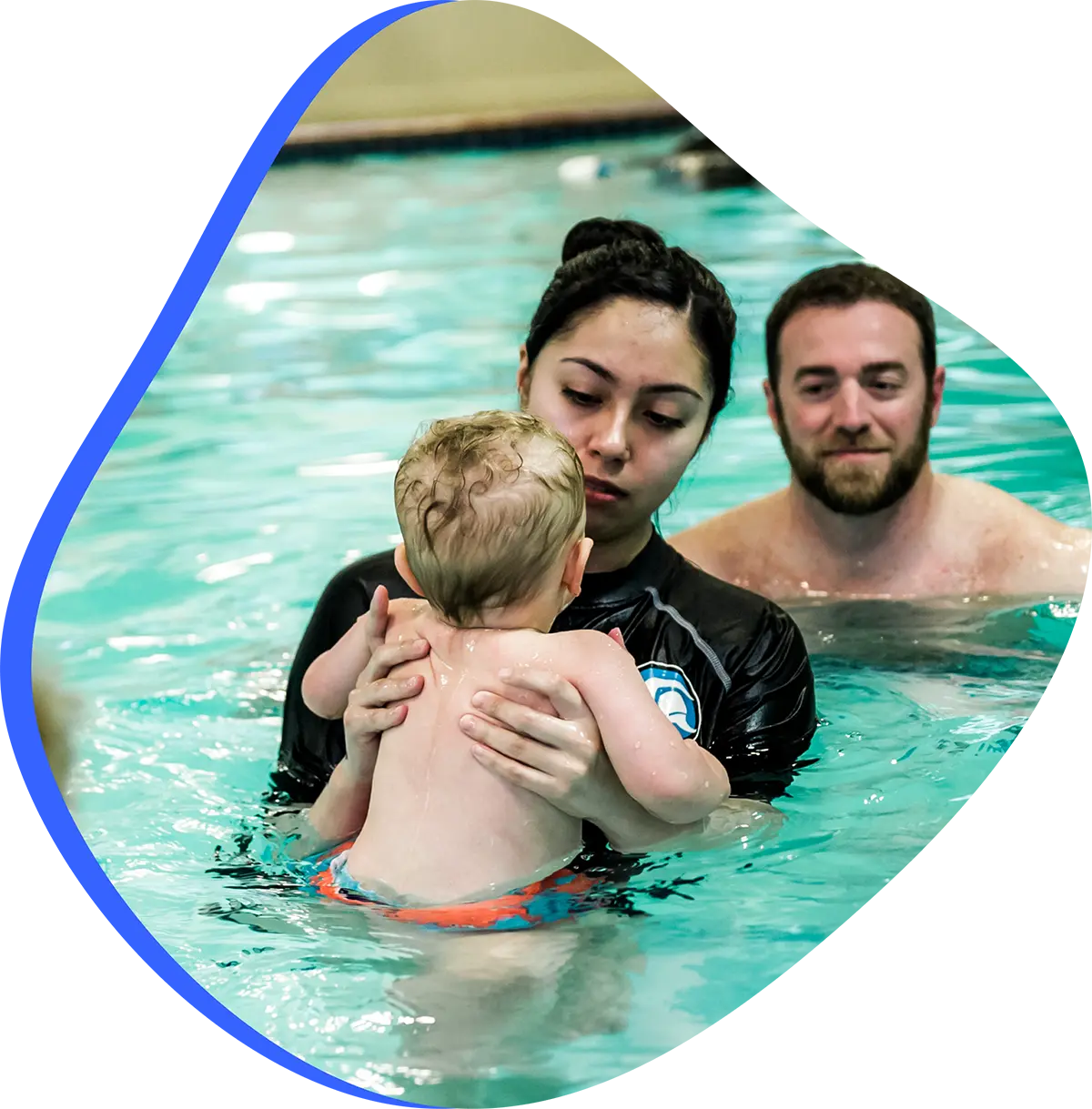 Child practicing one-on-one swim lesson with instructor at FINS Swim School.