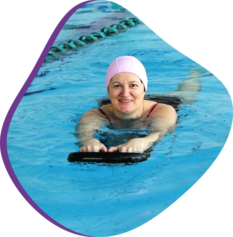 An adult swimmer receiving personalized one-on-one coaching from a FINS instructor in Atascocita.