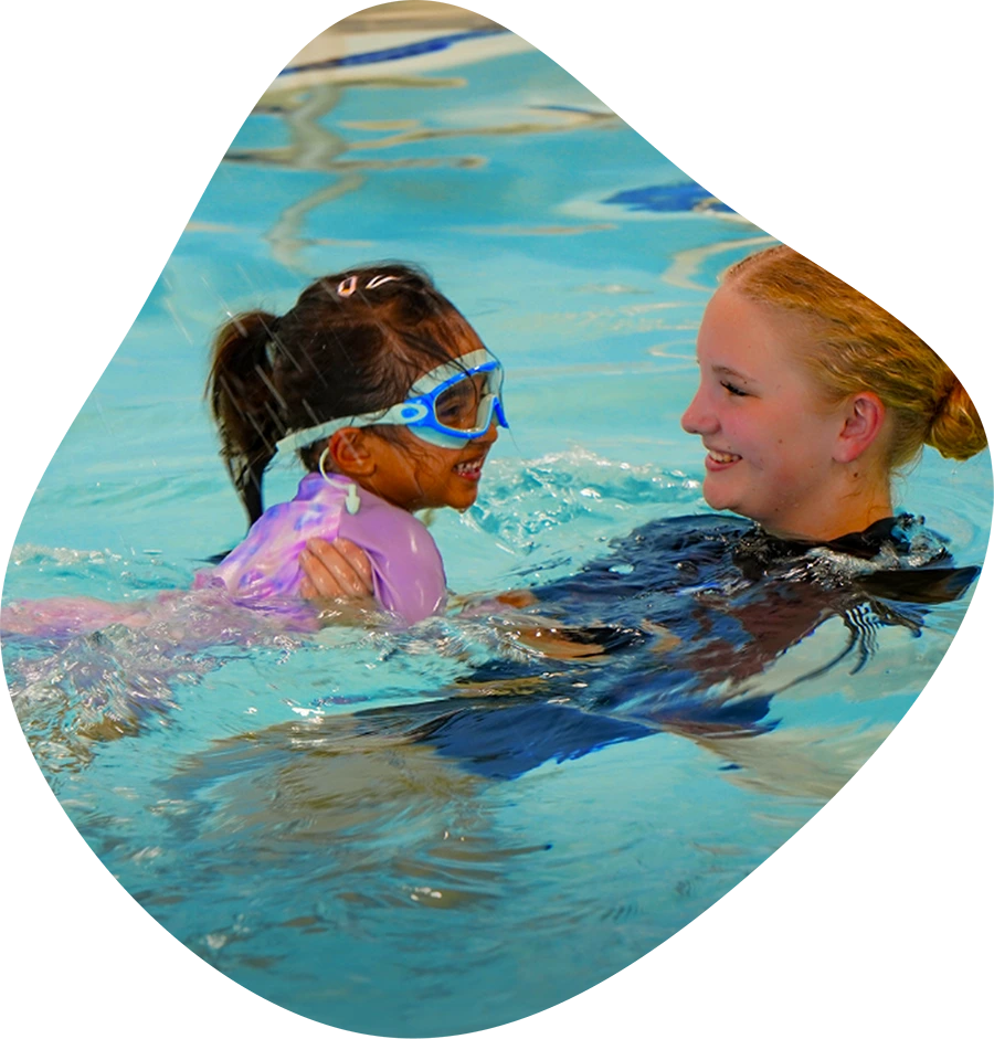 A student and instructor practicing swim techniques in The Woodlands, TX, indoor facility.