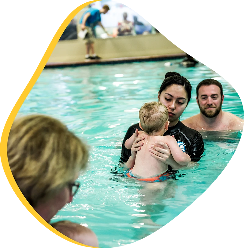 A parent and infant participating in a gentle water acclimation class at FINS Atascocita.