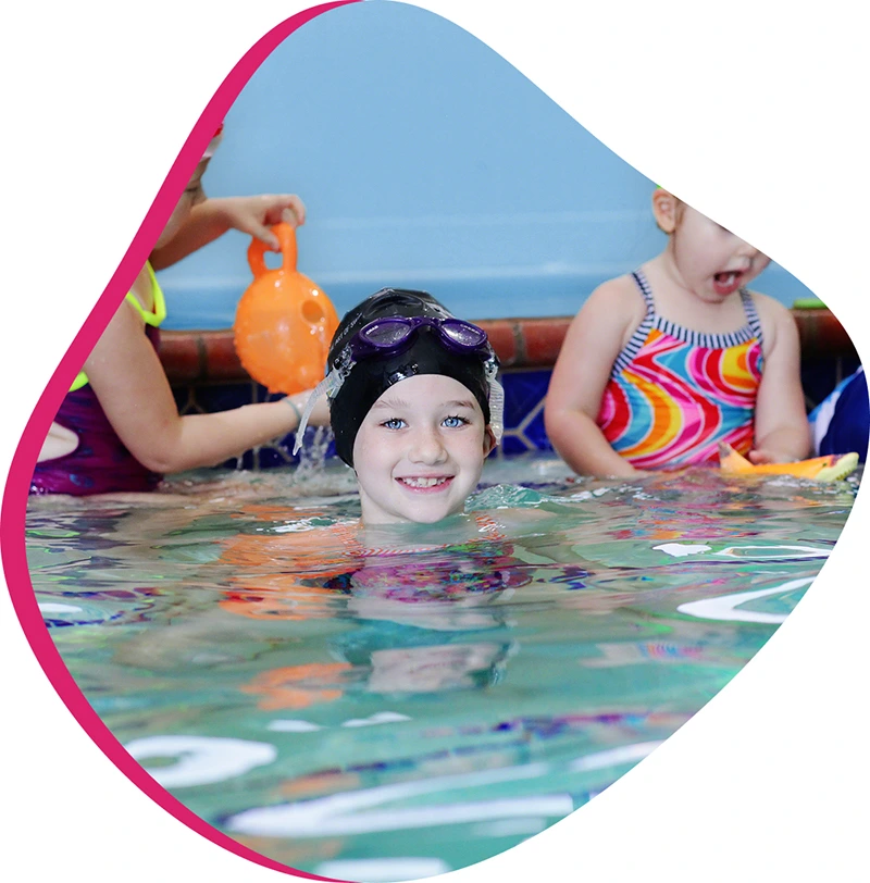 A child practicing competitive stroke technique during a private swim lesson at FINS Swim School.