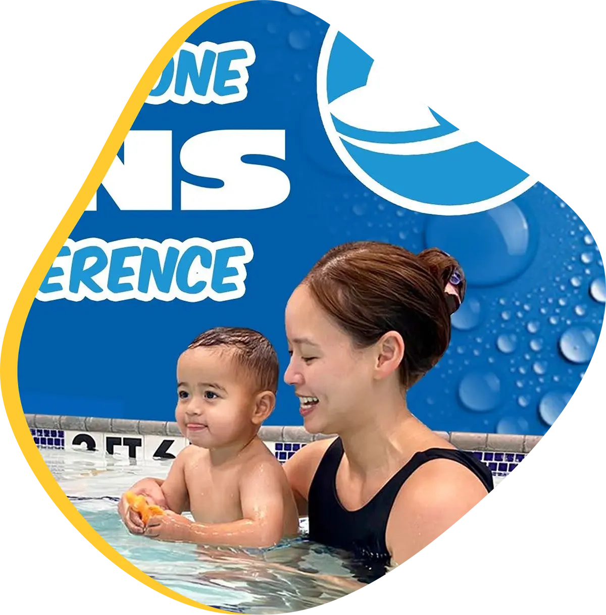 Child learning to swim with instructor at FINS Swim School.