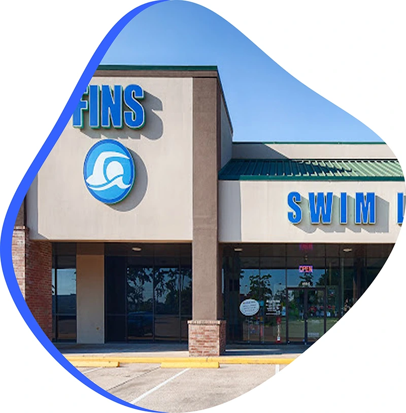 A young swimmer practicing freestyle stroke during a private one-on-one swim lesson at FINS Atascocita.