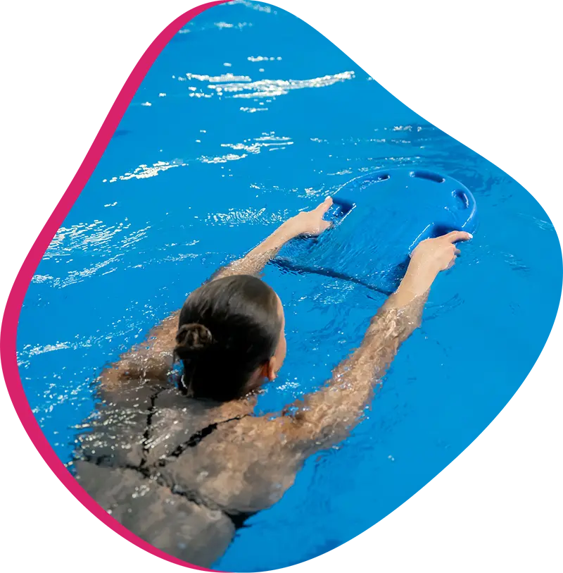 An adult swimmer receiving personalized one-on-one coaching from a FINS instructor in Atascocita.
