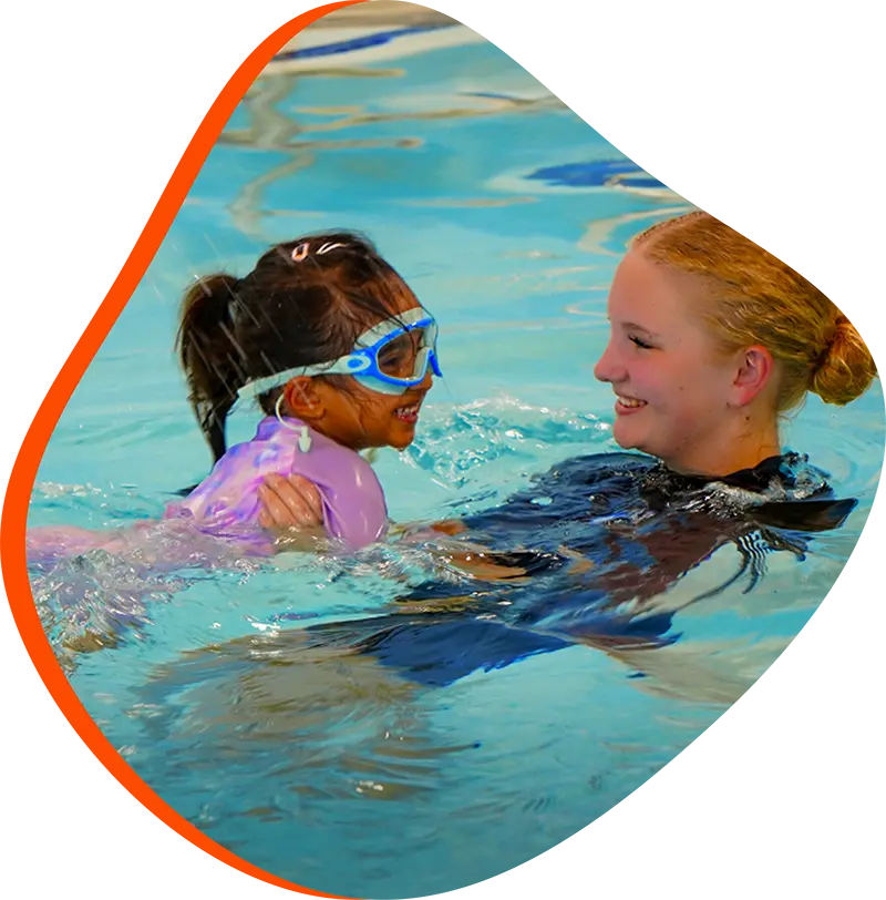 A young swimmer practicing freestyle stroke during a private one-on-one swim lesson at FINS Cypress.