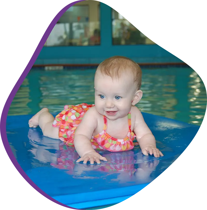 A parent and infant bonding during a gentle water acclimation session at FINS Cypress.