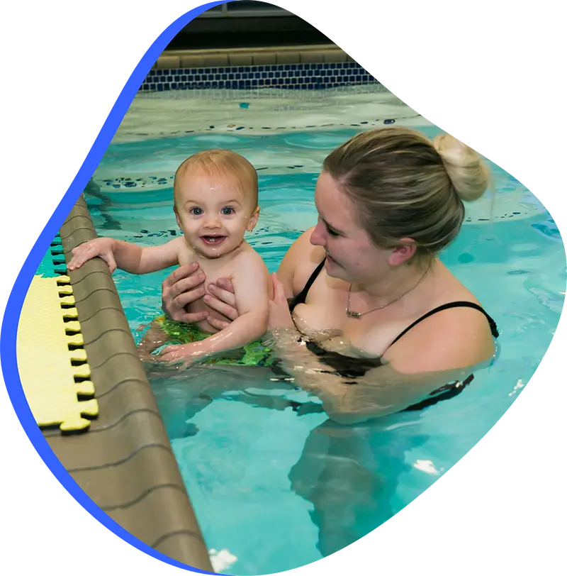 A parent and infant participating in a gentle water acclimation class at FINS Cypress.
