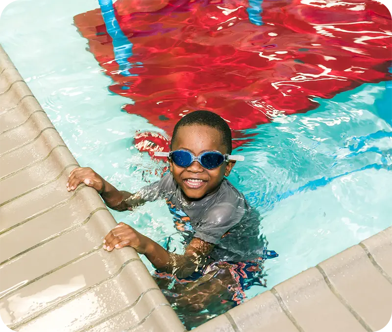 A student and instructor practicing swim techniques in The Woodlands, TX, indoor facility.