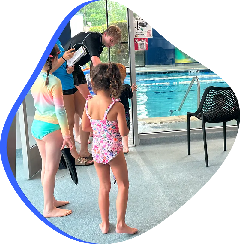 A young swimmer practicing freestyle stroke during a private one-on-one swim lesson at FINS Fleet.