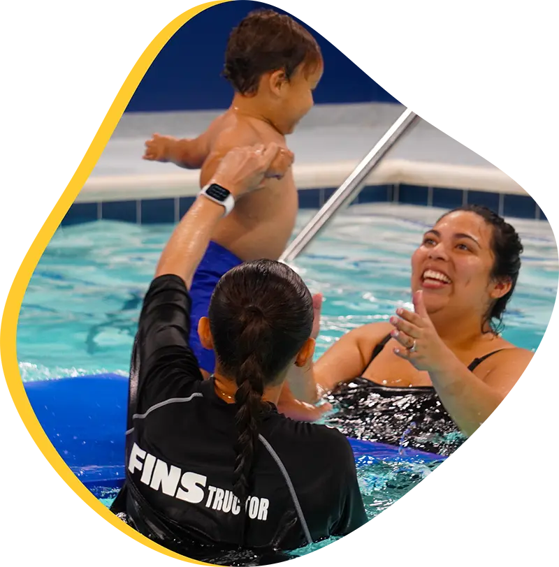 A young swimmer practicing freestyle stroke during a private one-on-one swim lesson at FINS Fleet.