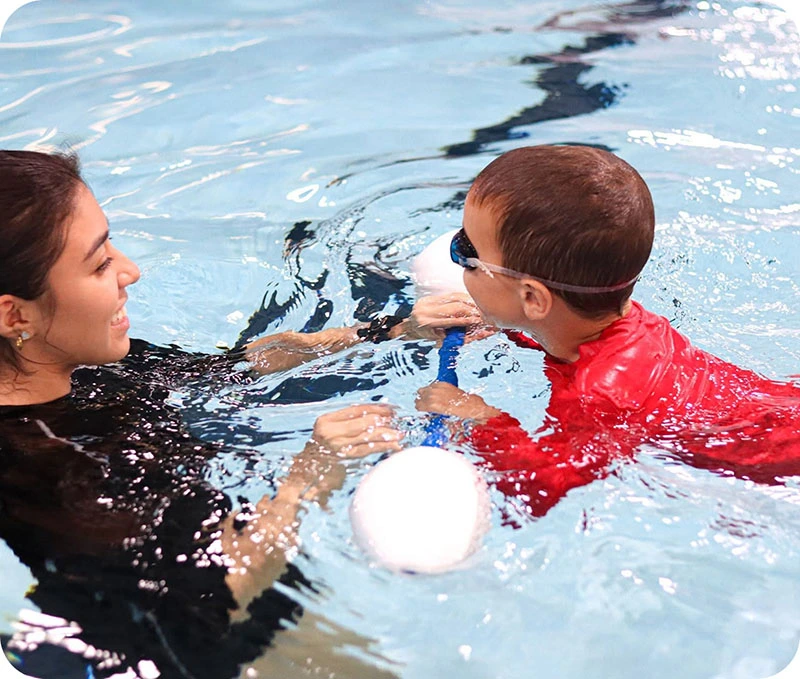 Photos of swim lessons and community events at FINS Swim School Cypress