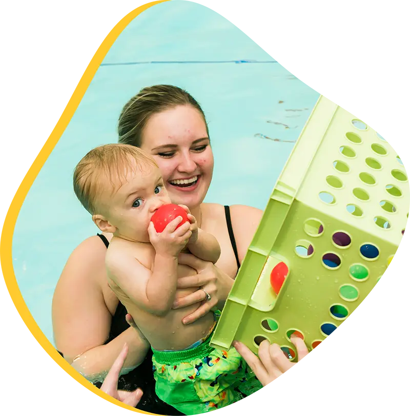 A parent and infant participating in a gentle water acclimation class at FINS Grand Parkway.