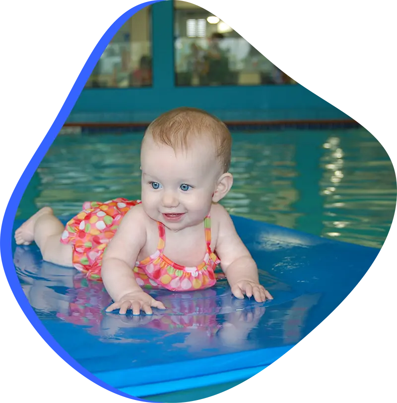 A parent and infant participating in a gentle water acclimation class at FINS Grand Parkway.