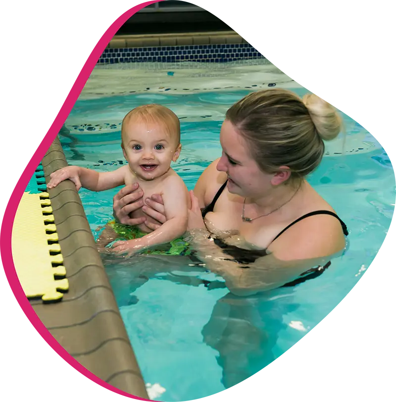 A parent and infant participating in a gentle water acclimation class at FINS Grand Parkway.