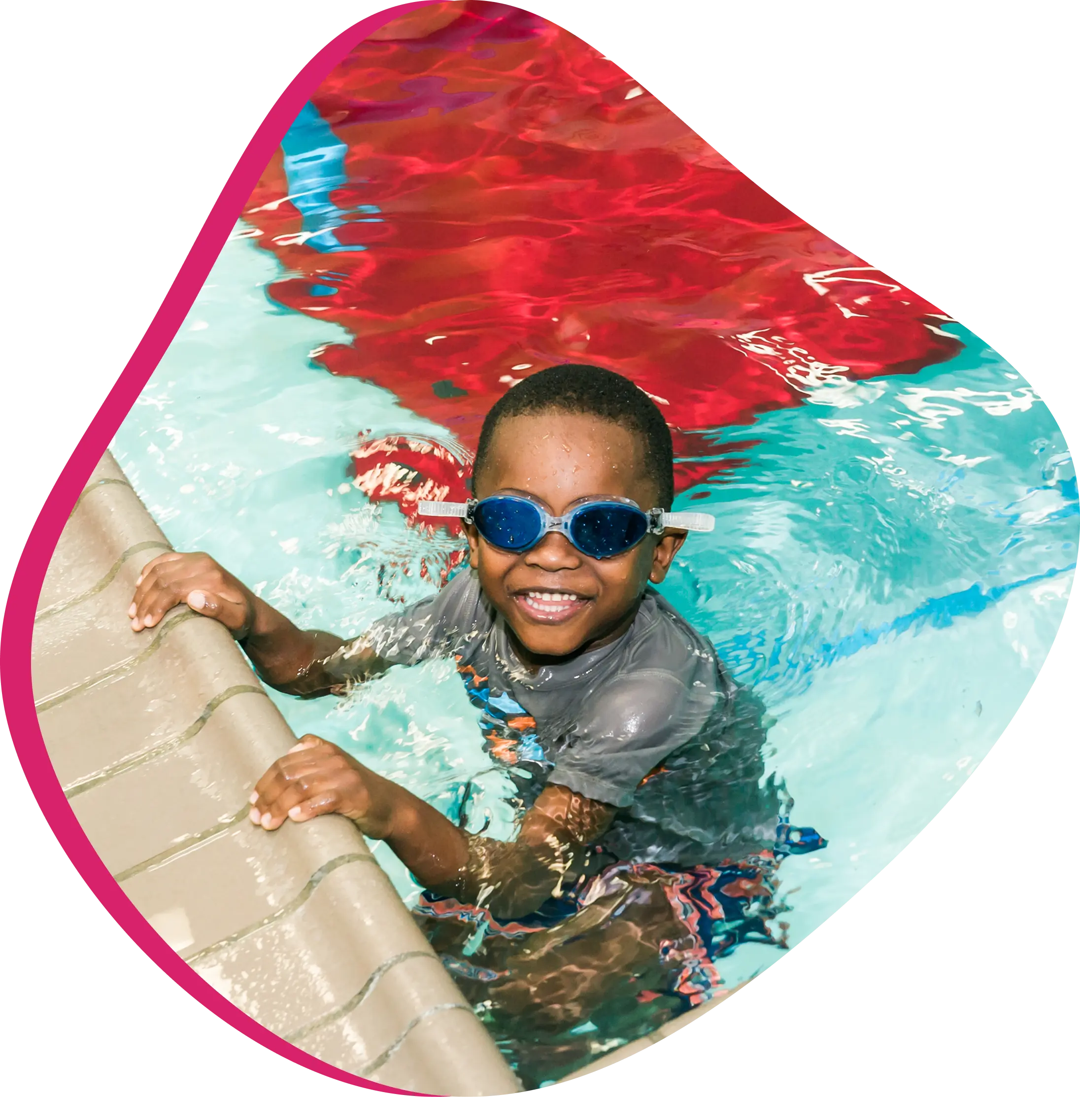 A young swimmer practicing stroke technique with a professional instructor at FINS Grand Parkway.