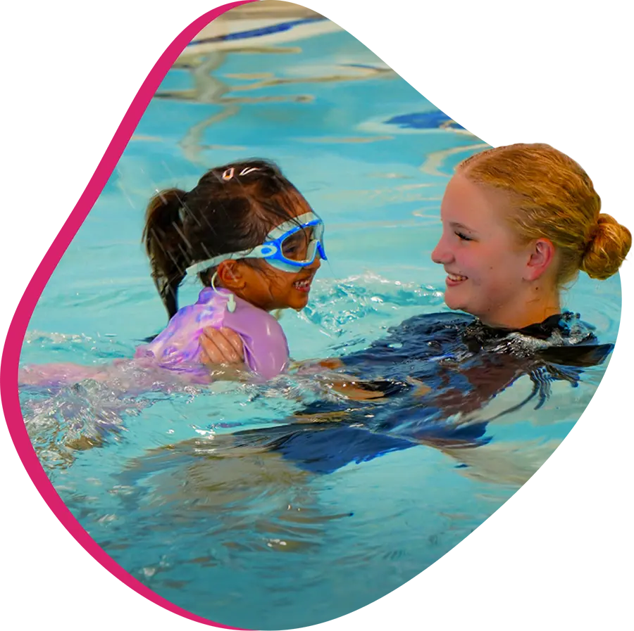 A dedicated FINS instructor providing one-on-one swimming guidance to a young student.