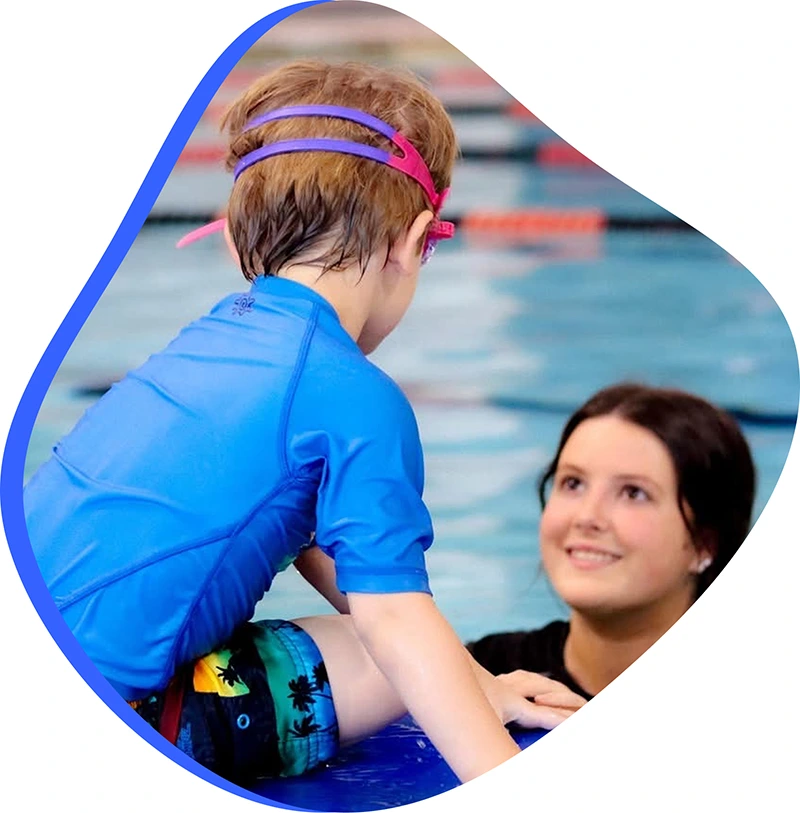 A school-aged child practicing correct freestyle stroke technique during a private 1-on-1 swim lesson.