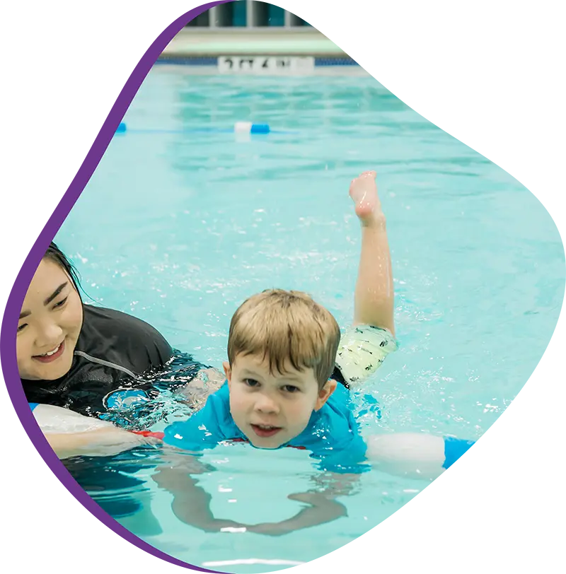 A parent and infant participating in a gentle water acclimation class at FINS Atascocita.