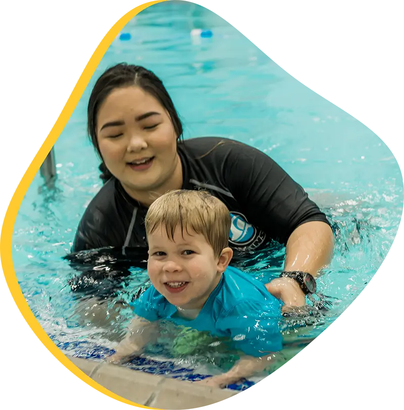 A parent and infant participating in a gentle water acclimation class at FINS Atascocita.
