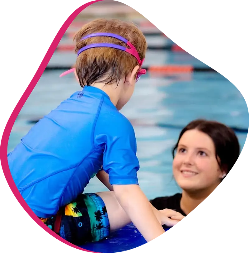 Young swimmer practicing freestyle technique during a private swim lesson at FINS Spring indoor pool.