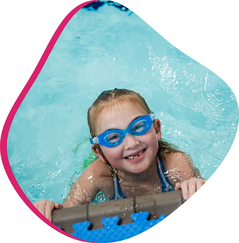 A young swimmer practicing freestyle stroke during a private one-on-one swim lesson at FINS Atascocita.