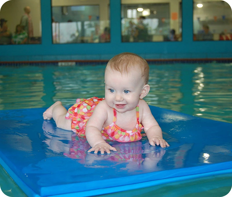 A student and instructor practicing swim techniques in The Woodlands, TX, indoor facility.