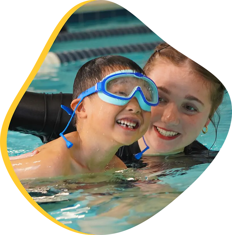 A child swimmer practicing efficient freestyle strokes during a private lesson at FINS The Woodlands.