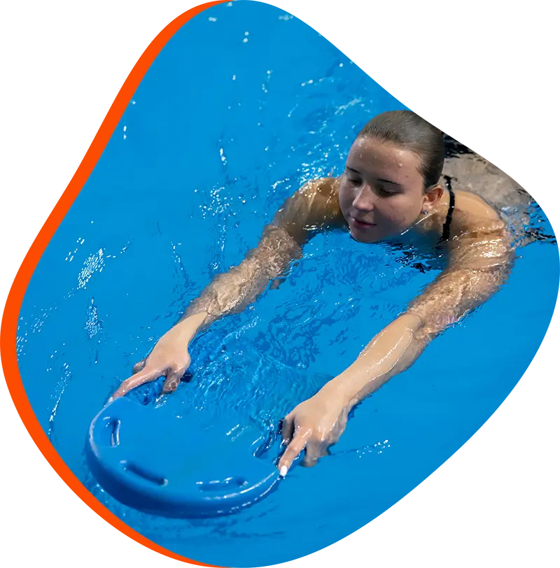 An adult swimmer receiving personalized one-on-one coaching from a FINS instructor in The Woodlands.