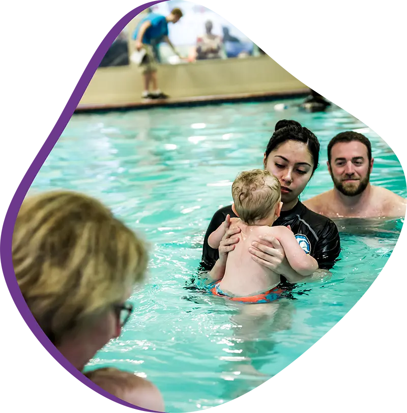A parent and infant participating in a gentle water acclimation class at FINS 2978.