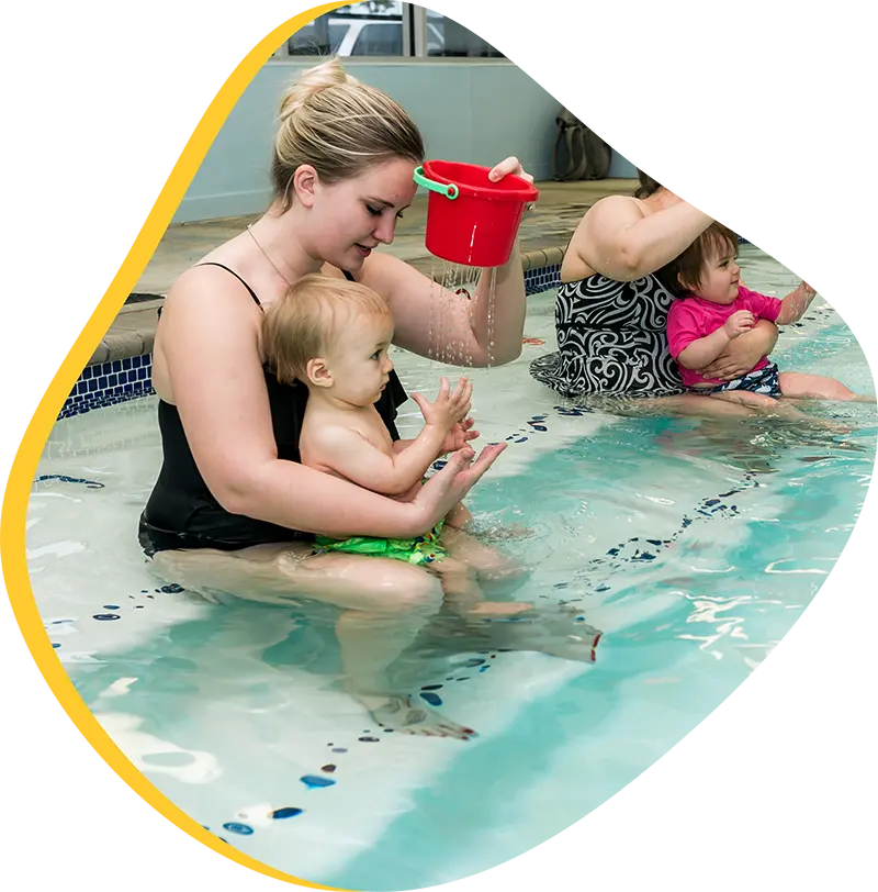 A parent and infant participating in a gentle water acclimation class at FINS 2978.