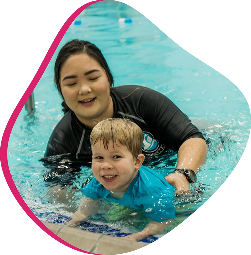 A young swimmer practicing freestyle stroke during a private one-on-one swim lesson at FINS The Woodlands 2978.