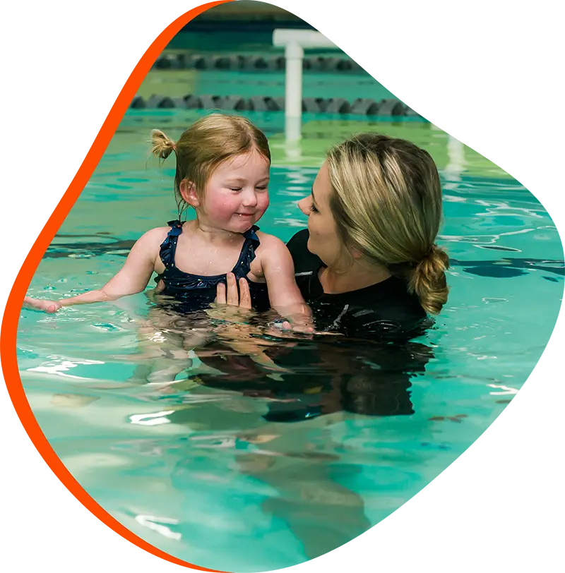 A young swimmer practicing freestyle stroke during a private one-on-one swim lesson at FINS The Woodlands 2978.