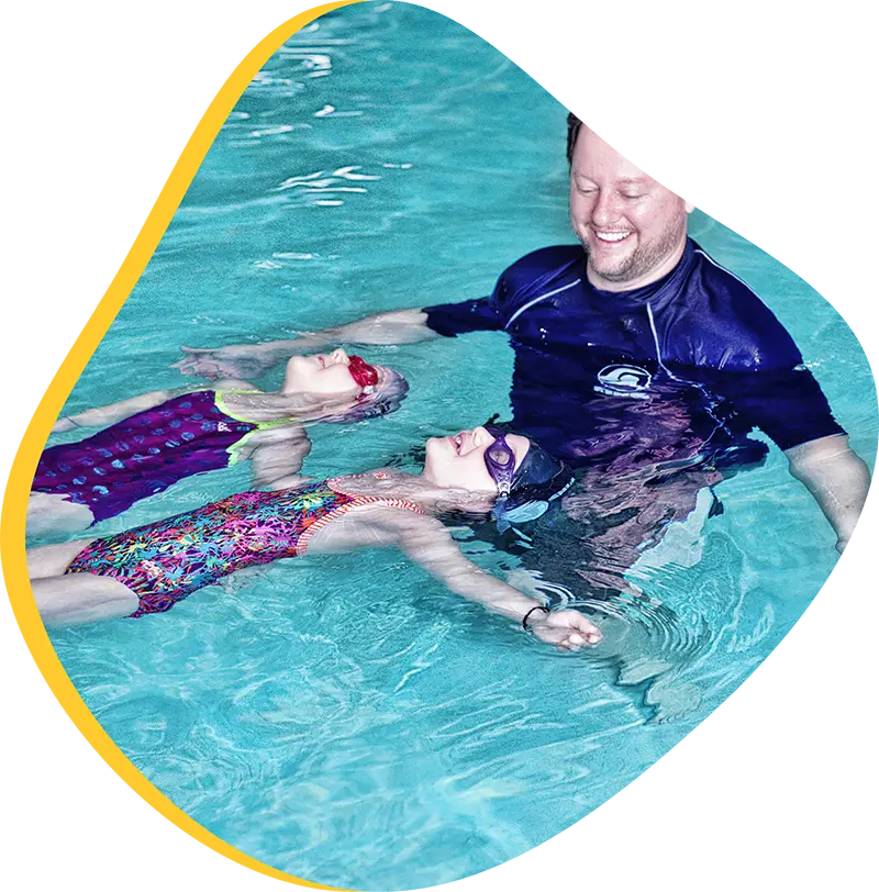 A young swimmer practicing freestyle stroke during a private one-on-one swim lesson at FINS The Woodlands 2978.