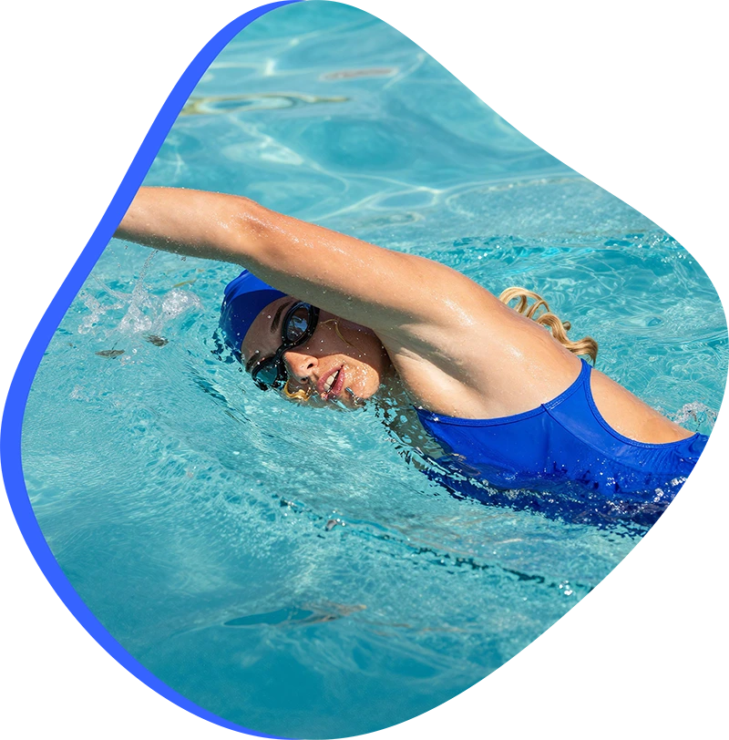 A young swimmer practicing freestyle stroke during a private one-on-one swim lesson at FINS The Woodlands 2978.