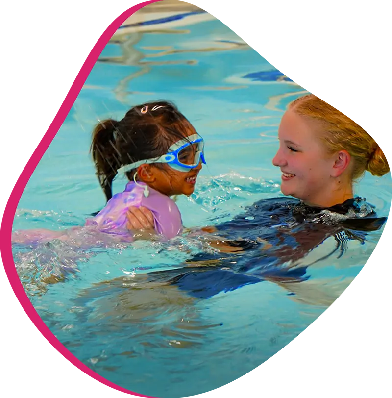 A FINS swim instructor helping a child build confidence during a private swim lesson.