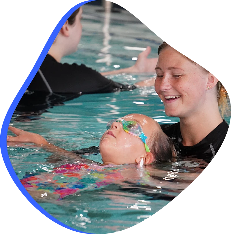 A child practicing competitive stroke technique during a private swim lesson at FINS Swim School.